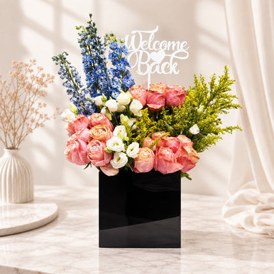 Welcome Back Pink Rose & Blue Delphinium Flower Arrangement in Elegant Black Box