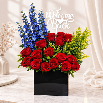 Welcome Back Red Rose & Blue Delphinium Flower Arrangement in Elegant Black Box